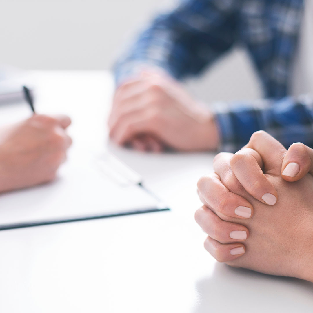 Doctor woman offering medical advices to young couple in office